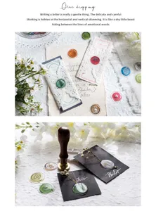 Close-up detail of wax seal stickers and glue dropping craft materials for creative scrapbooking.