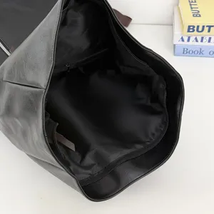 Black roll-top backpack interior detail, large capacity design for daily commuting and college.
