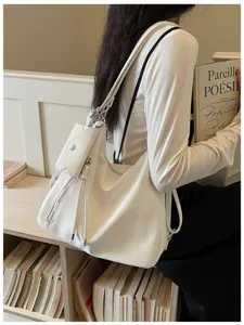 Casual minimalist white slouchy shoulder bag and multi-use backpack for women commute daily use.