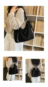 Detail shot of black slouchy convertible shoulder backpack, large capacity commuter tote bag.