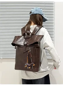 Stylish dark brown leather roll-top backpack for daily commute, large capacity laptop bag.