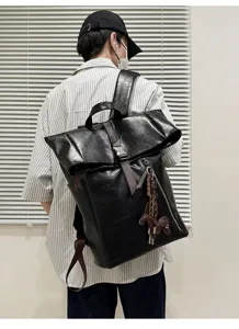 Black PU leather roll top backpack with large capacity for men commute and casual daily use.