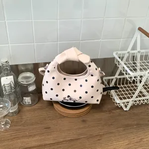 Borsa a mano rosa a pois con manico a fiocco elegante borsa a tracolla per donna moderna.