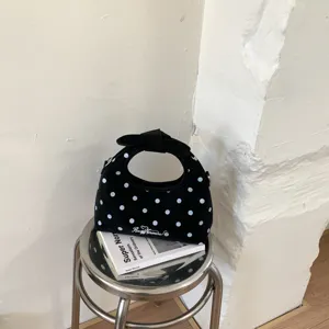 Borsa a mano nera a pois con fiocco, manico rotondo chic, elegante borsa a tracolla da donna.