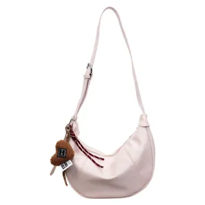 Korean style pink PU leather crescent shoulder bag with cute plush heart pendant.