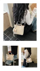 Detail view of the chic off-white women handbag with lovely plush charm for daily style.