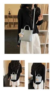 Chic women's crossbody handbag with cute bear charm, casual stylish light blue tote bag.