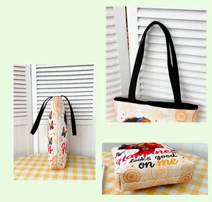 Large capacity canvas tote bag with artistic print, comfortable shoulder straps for daily use.