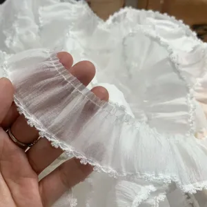White sheer organza ruffled lace trim detail close-up for DIY apparel, doll clothes and hair accessories.