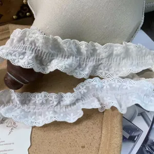 Detail view of 4.5cm off-white ruffled cotton lace trim, perfect for DIY sewing and apparel decor.