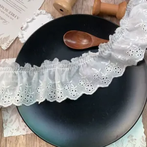 Detailed view of 6.5cm white hollow embroidered flower pleated lace trim for DIY crafts.