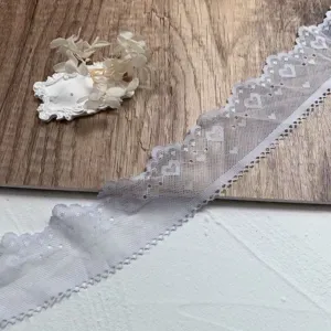 Close-up of 5cm white heart embroidered lace trim, ideal for DIY crafts and doll clothes.