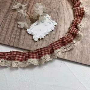 Close-up detail of red and white plaid ruffled lace trim, perfect for DIY sewing and crafts.
