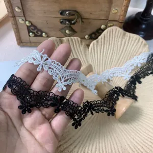 Close-up detail of black and white floral water-soluble lace trim for DIY craft sewing projects.