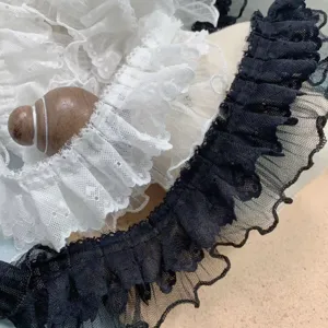 Close-up detail of double-layer ruffled lace trim featuring delicate mesh texture for DIY decor.
