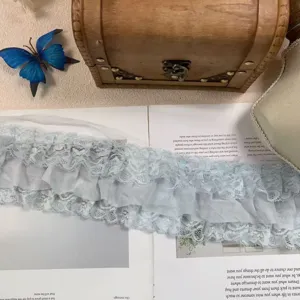 Detailed view of 10cm wide light blue three-layer chiffon lace ruffle trim for DIY crafts.