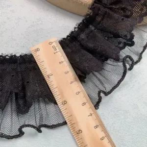 Close-up detail of black double layer lace ruffle trim, showing width with a ruler clearly.