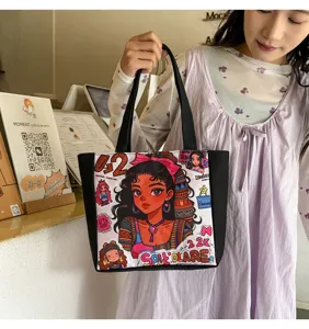 Nuevo bolso de hombro de lona con estampado de niña negra, bolso tote cartoon para mujer casual chic.