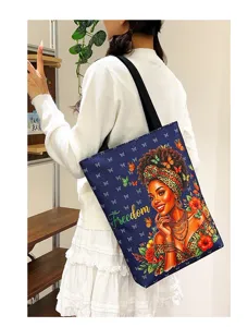 Detail view of a large capacity canvas shoulder bag featuring an artistic African woman print.