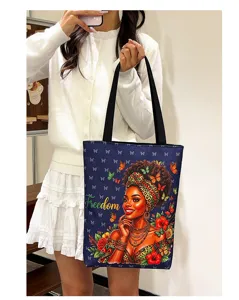 Canvas tote bag detail showing African woman art print, floral pattern and shoulder strap design.