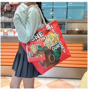 Sac cabas en toile et petite pochette assortie avec graphique de fille noire et texte.