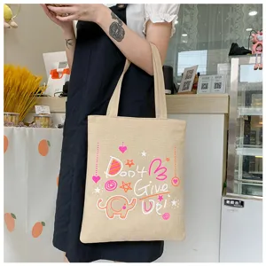 Dettaglio di una borsa shopper in tela casual con stampa di elefante e citazione motivazionale.