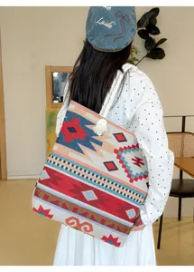 Detail shot of large capacity ethnic totem canvas shoulder tote bag with sturdy rope straps.