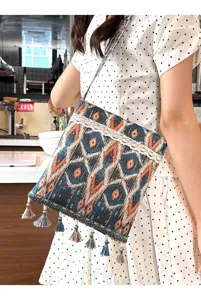 Bolso cruzado tejido de estilo étnico con ribete de encaje y borlas para uso diario.