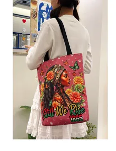 Grand sac cabas en toile avec bandoulière noire et imprimé artistique de femme africaine.