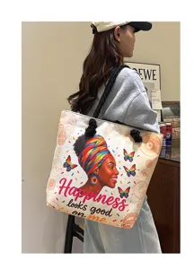 Gedetailleerd uitzicht op de stijlvolle canvas tote bag met een Afrikaanse vrouwenprint.