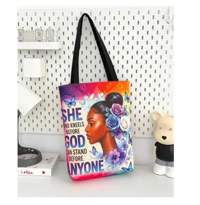 Sac cabas en toile avec anses noires, doté d'un portrait de femme et imprimé motivant.