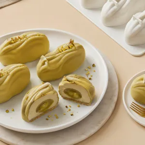Pistachio mousse cake detail view showing creamy texture and filling inside silicone mold baking.