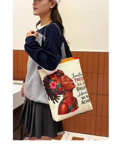 Close-up detail of the canvas tote bag featuring an artistic Black woman print and inspiring text.