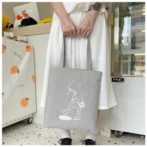 Vista dettagliata della borsa shopper in tela grigia, borsa casual con simpatico disegno.