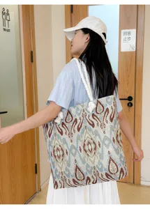 Ethnic embroidered canvas tote bag with thick rope handles, casual large shoulder bag detail.