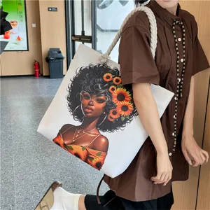 Detailed view of casual canvas tote bag with West African art print and thick rope handles.