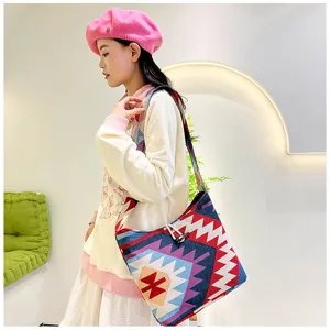 Ethnic style canvas shoulder bag for women, fashionable crossbody bag with geometric woven pattern.