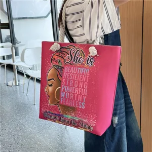 Canvas beach tote bag detail showing African woman graphic and inspirational text print.
