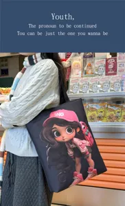 Canvas tote bag with cute cartoon girl print, large capacity black shoulder bag for students.