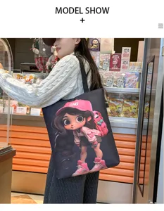Stylish black canvas shoulder bag with cute cartoon girl print, large capacity daily tote.