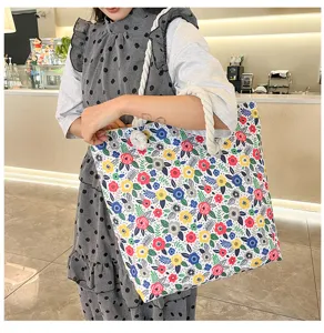Canvas tote bag with colorful floral print and thick rope handles for women beach casual use.