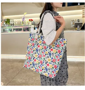 Casual canvas tote bag with double-sided floral pattern and hemp rope handles for beach shopping.