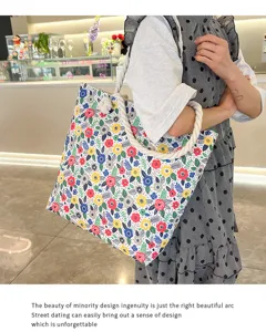 Detail view of a fashionable floral canvas beach bag with thick rope shoulder straps for women.