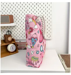 Pink canvas beach tote bag with cute cartoon prints and thick rope handles for women.