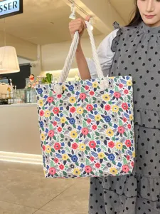 Casual canvas beach tote bag for women with double-sided floral print and stylish rope handles.