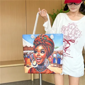 Close-up detail of the African art canvas tote bag showing the vibrant portrait and rope handle.