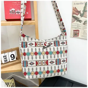Ethnic style woven shoulder canvas cross-body bag with colorful geometric patterns and button.