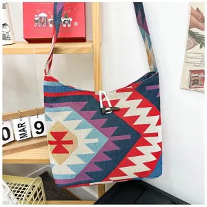 Ethnic style woven canvas shoulder crossbody bag with geometric patterns and toggle closure.