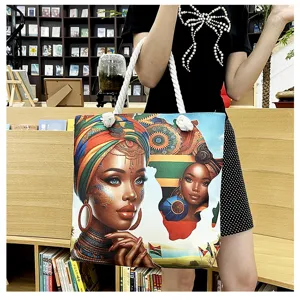 Leinwand Tragetasche für Damen mit afrikanischem Kunstporträt Druck und weißen Seilgriffen.
