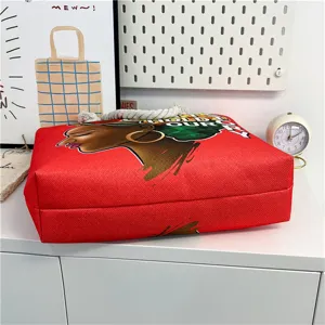 Red canvas tote bag detail view, ethnic portrait pattern with thick rope handle, beach casual bag.